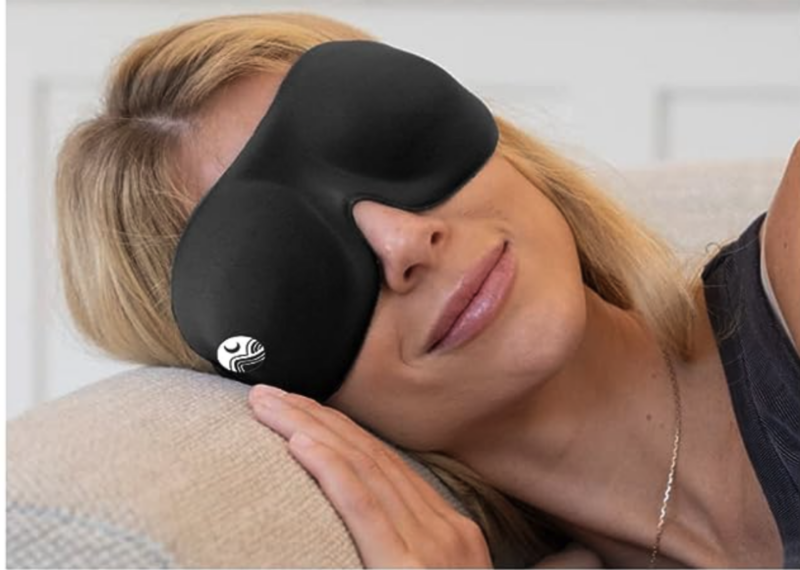 Woman in bed wearing Nidra Sleep Mask